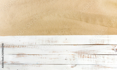 Sand on a white planked wood. Summer background. Flat lay, top view, copy space 