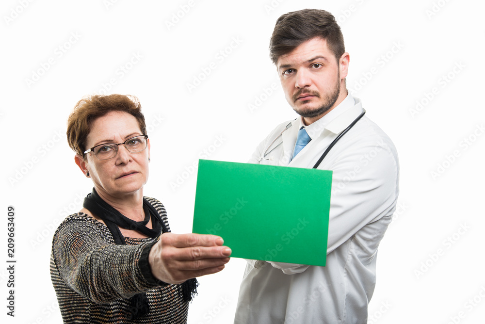 Female senior patient showing green board to male doctor Female senior patient showing green board to male doctor