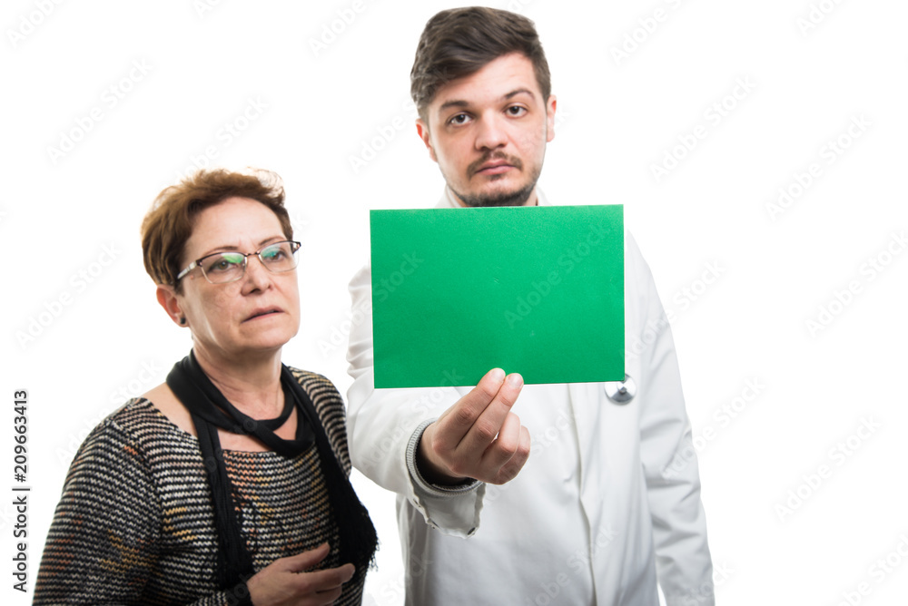 Both male doctor and female patient looking to green board Both male doctor and female patient looking to green board