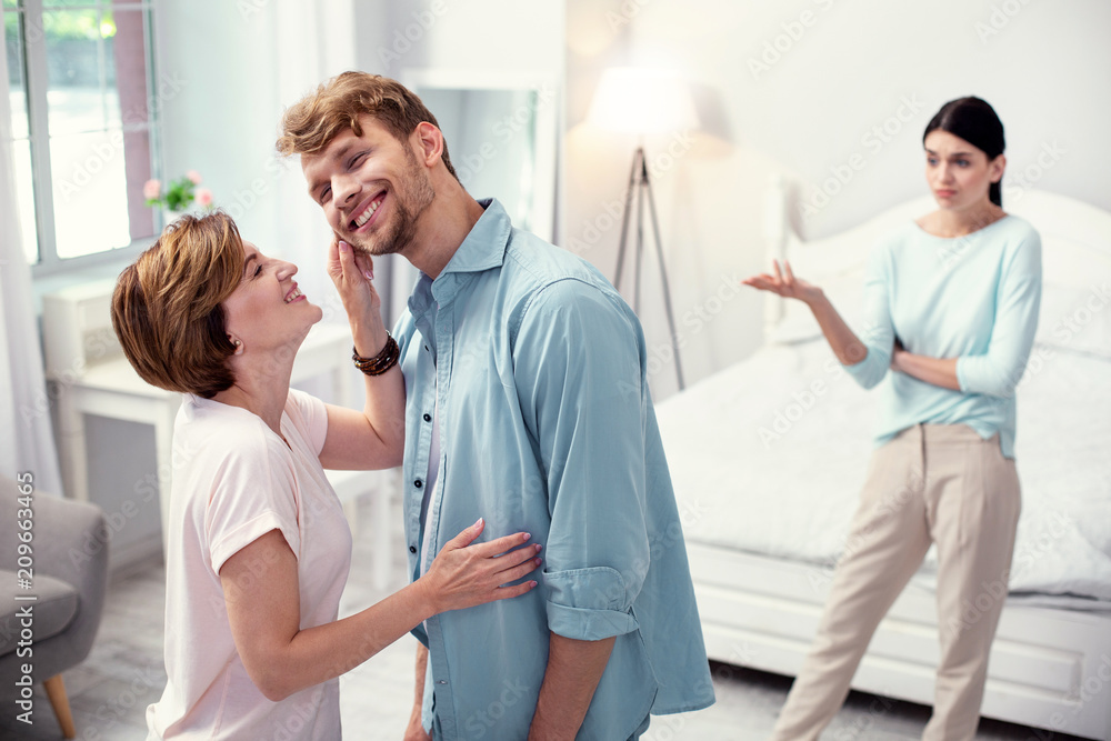 Pleasurable mood. Happy joyful woman looking at her son while enjoying her time with him Pleasurable mood. Happy joyful woman looking at her son while enjoying her time with him