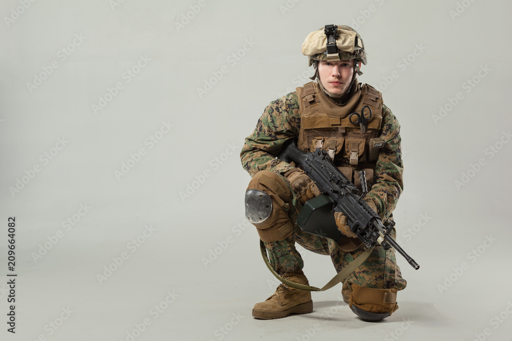 Soldier in camouflage holding rifle Soldier in camouflage holding rifle