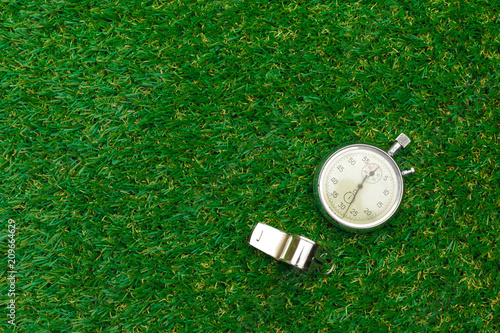 Fotografie Silver chronometer on green grass