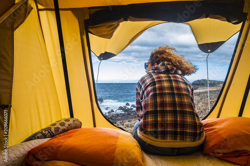 Εκτύπωση καμβά nice woman view from backside sitting outside of a tent mounted on a car