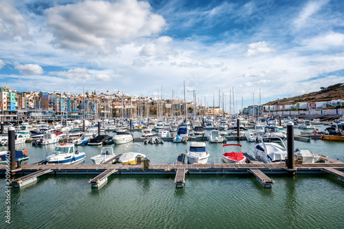Port in the bay of Albufeira, Portugal, many boats and yachts in the background of the city, a popular destination for travel and recreation in Europe