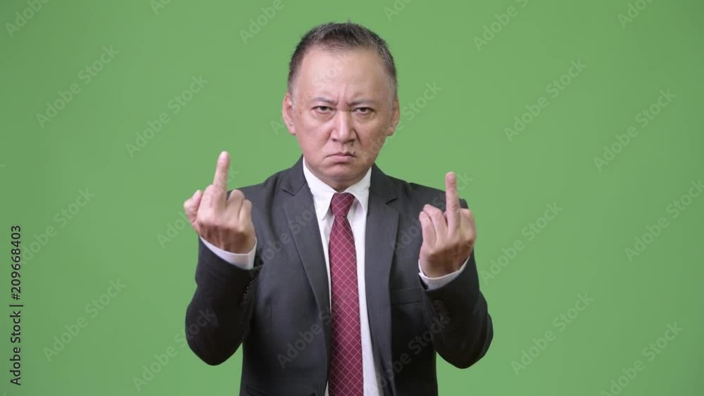 Mature Japanese businessman showing middle fingers Mature Japanese businessman showing middle fingers