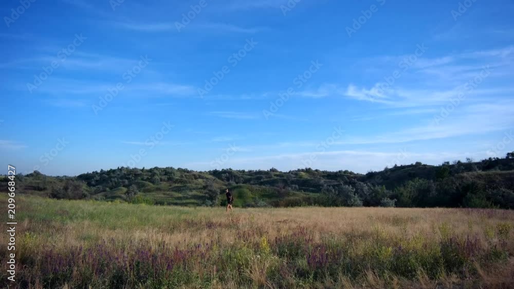 a man hiker travels on hilly terrain a man hiker travels on hilly terrain
