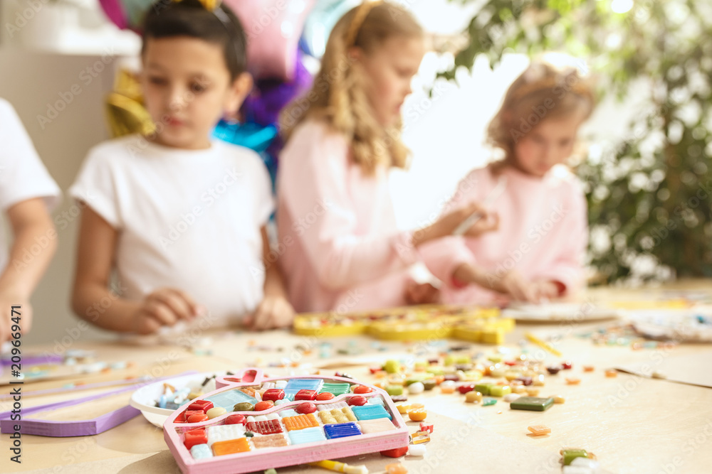 mosaic puzzle art for kids, children's creative game. two sisters are playing mosaic mosaic puzzle art for kids, children's creative game. two sisters are playing mosaic