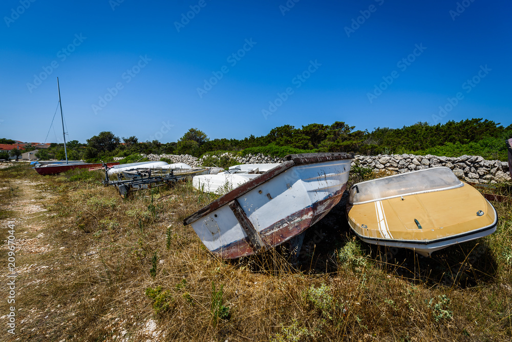 Old abandoned wrecked speed boat at ship or boat graveyard. Old abandoned wrecked speed boat at ship or boat graveyard.