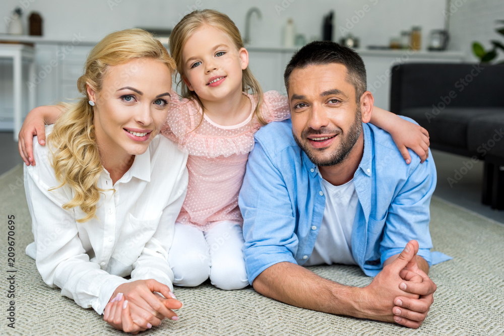 happy family with one child smiling at camera at home happy family with one child smiling at camera at home