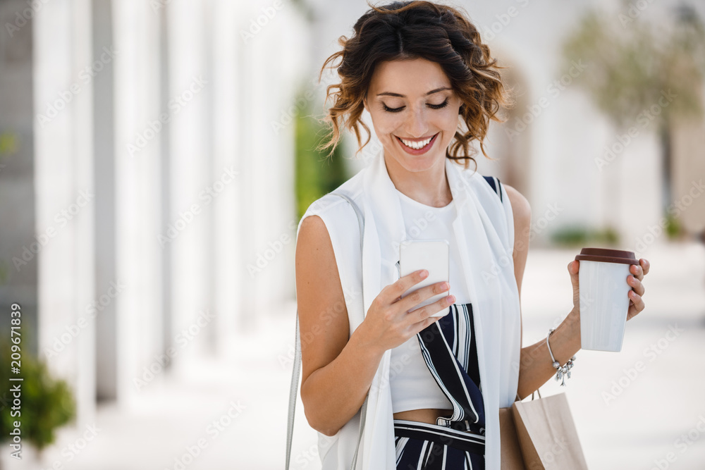 A Woman Shopper Holding Cell Phone - obrazy, fototapety, plakaty 