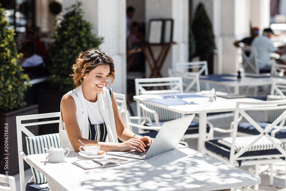 Fototapeta premium Woman Freelancer Working at Cafe