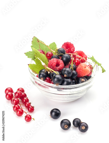 Mixed berries in glass bowl isolated on white background