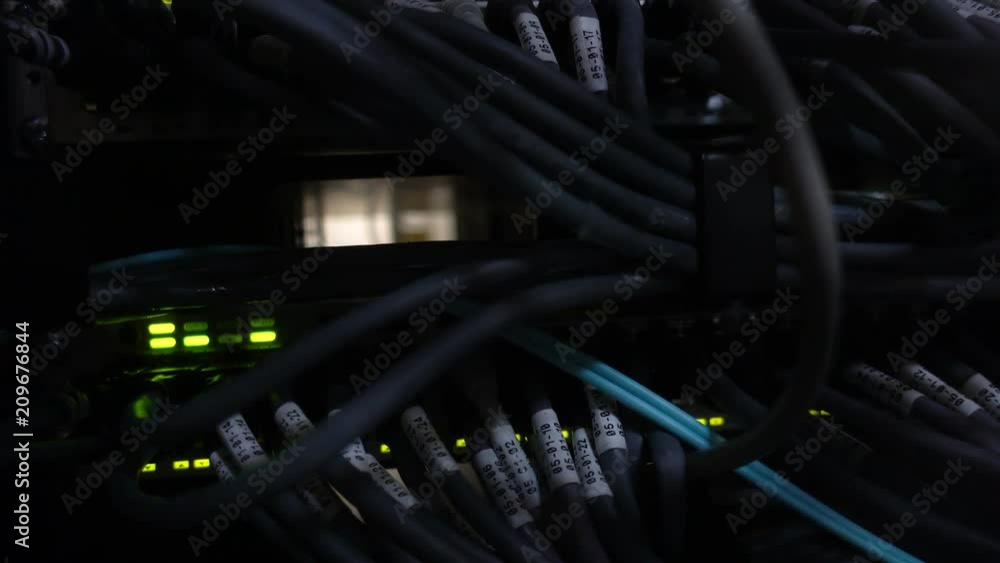 Working Ethernet switch in a dark data center room. Many flashing green lamps Working Ethernet switch in a dark data center room. Many flashing green lamps