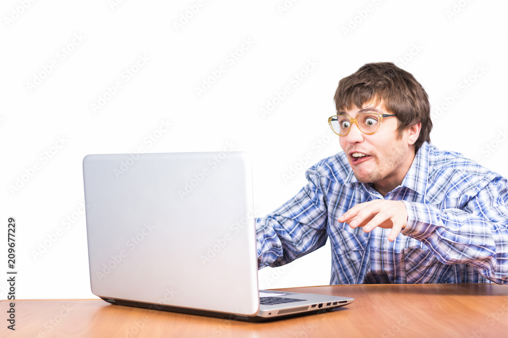 guy nerd in glasses with laptop sitting at table guy nerd in glasses with laptop sitting at table