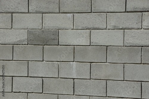 gray stone texture of bricks in the wall of a building