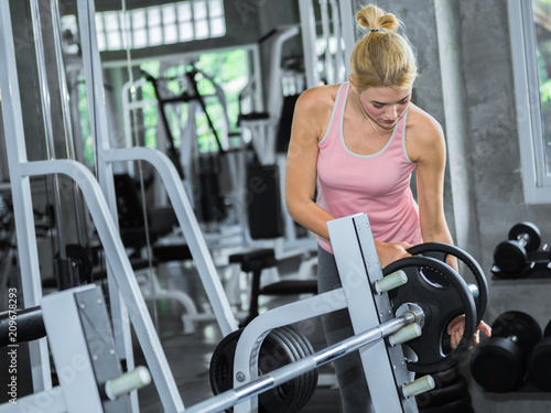 Beautiful woman prepare equipment for exercise