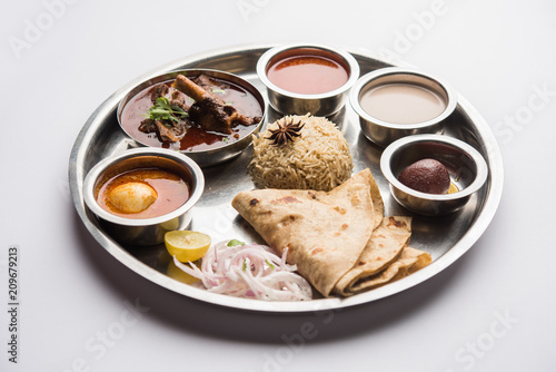 Motton Thali OR Gosht/Lamb platter is Indian/asian non veg lunch/dinner menu consists of meat, egg curry with chapati ,rice, salad and sweet Gulab Jamun photo