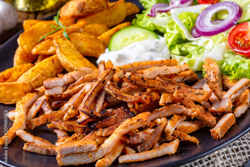 Rustic gyros plate it green salad and potato wedges © Dar1930