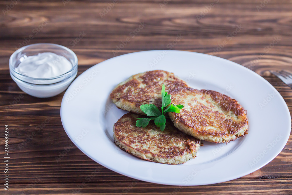 fried potato fritters with sour cream