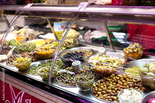 Bowls of olives for sale at a market shop-window
