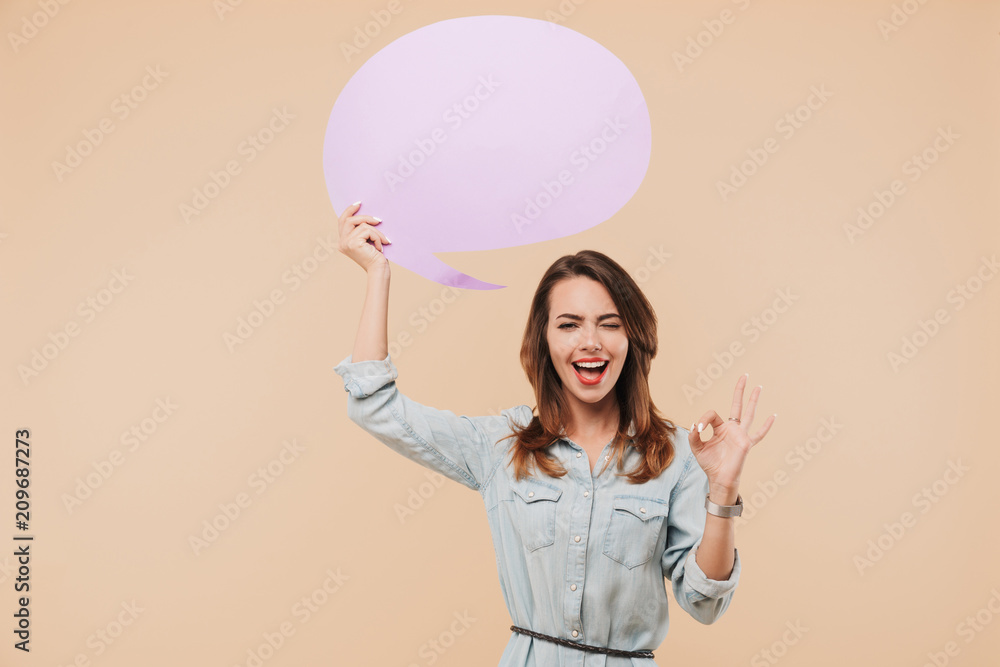 Happy woman holding speech bubble make okay gesture. Happy woman holding speech bubble make okay gesture.
