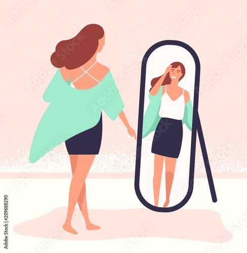 Young long-haired woman standing in front of mirror and looking at reflection. Beautiful girl dressing up. Female cartoon character viewing her outfit. Colorful vector illustration in flat style.