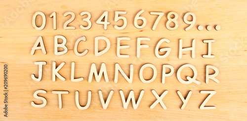 Wooden alphabet and numbers in order on the wooden background