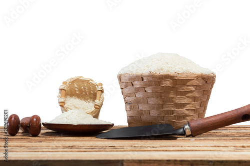 group of rice in bambooon basket on old wooden table photo