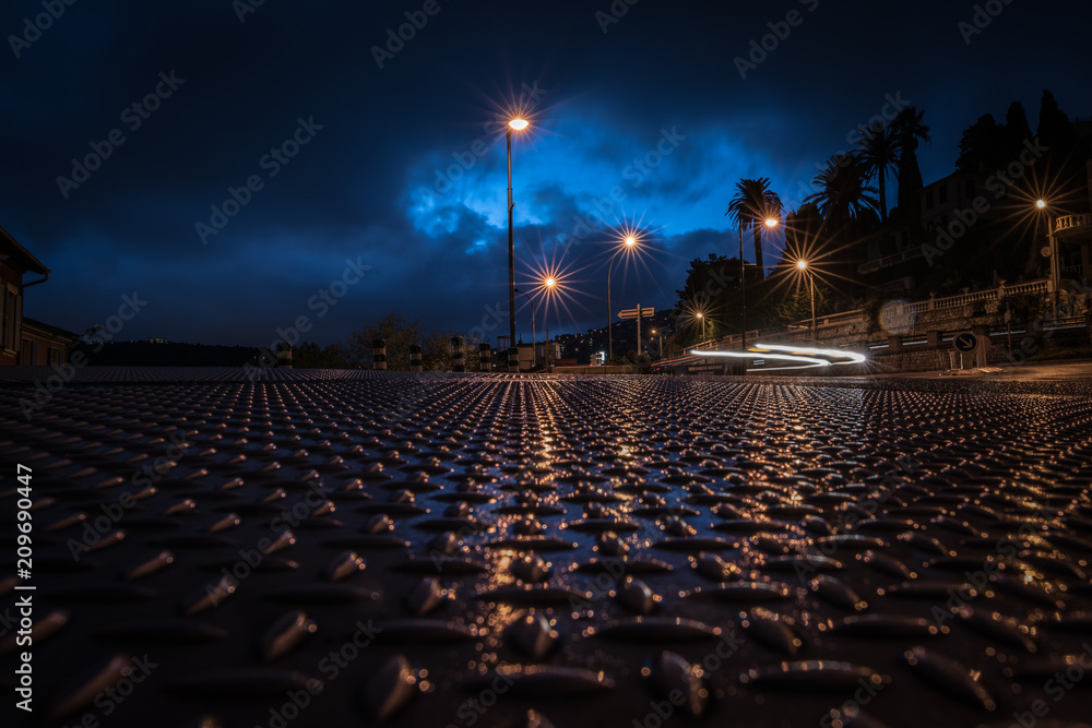 Fototapeta premium Urban night landscape with blurry car headlights