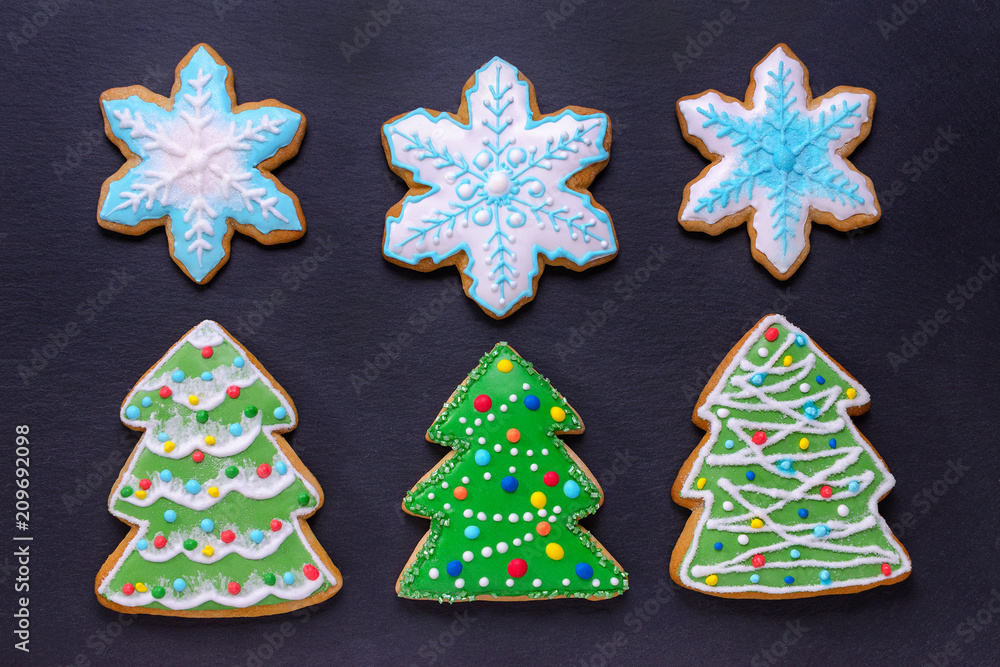 christmas food, handmade cookies gingerbread like christmas trees and snowflakes on black background christmas food, handmade cookies gingerbread like christmas trees and snowflakes on black background