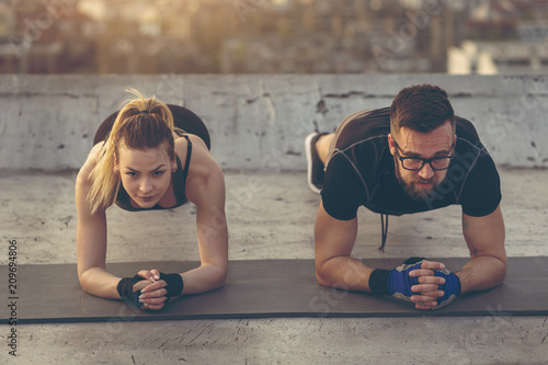 Couple doing a plank exercise photo