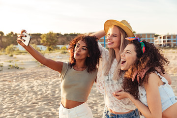 Three joyful girls friends in summer clothes