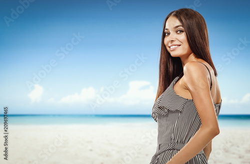 Beautiful young woman on the beach. Blurry beach and ocean background. © magdal3na