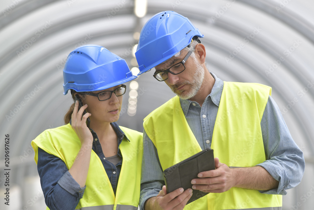 Industrial engineers working together using tablet Industrial engineers working together using tablet