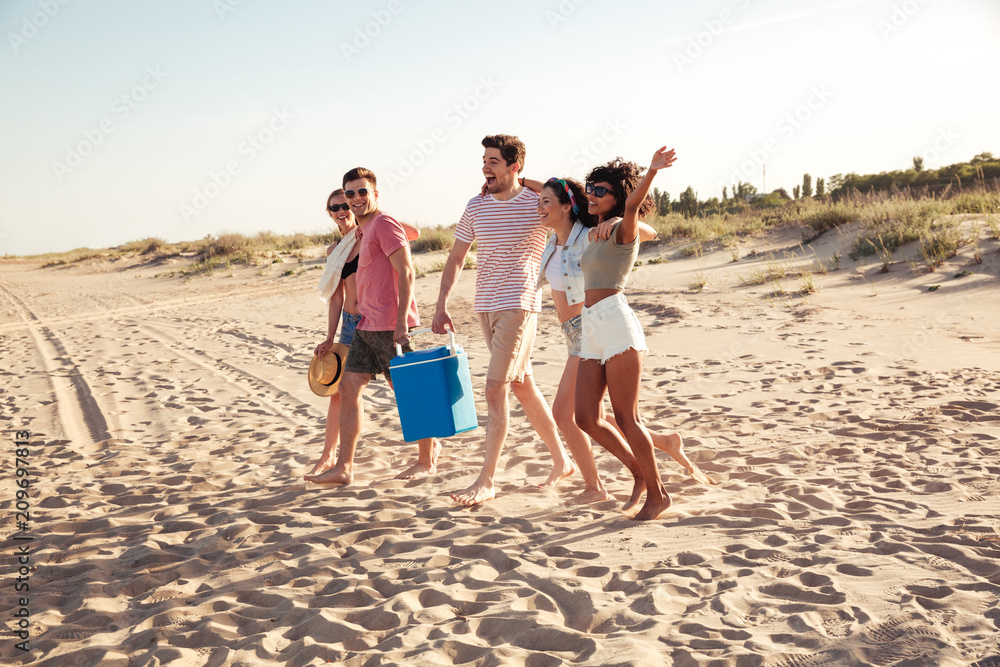 Group of excited young friends in summer clothes
