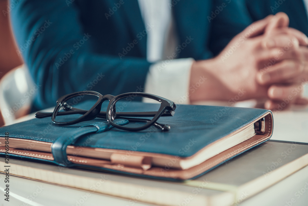 Close up man with glasses and notebooks in office. Close up man with glasses and notebooks in office.