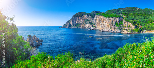 Beautiful summer panoramic seascape. View of Paleokastritsa famous beach in close bay with crystal clear azure water on Corfu island, Ionian archipelago, Greece. © Sodel Vladyslav