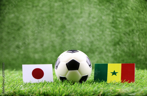 ball with Japan VS Senegal  flag match on Green grass football 2018