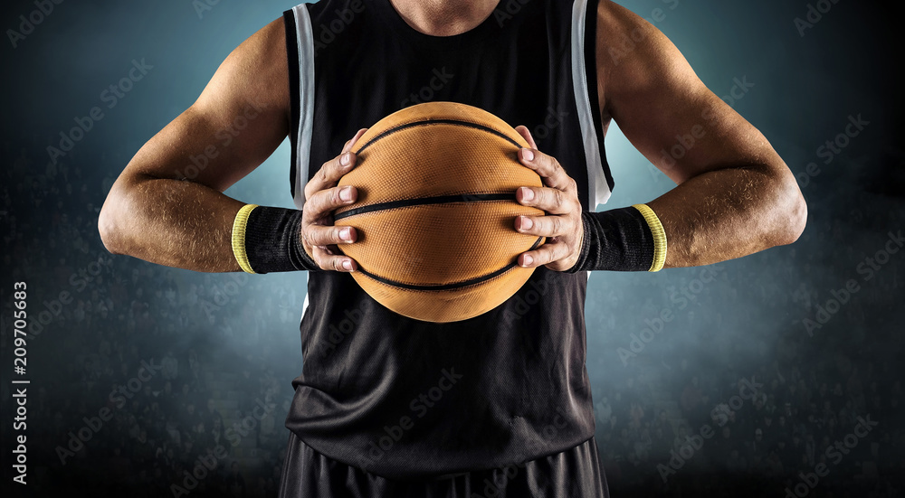 Basketball ball in a male hands, player in black with orange sport ball Basketball ball in a male hands, player in black with orange sport ball