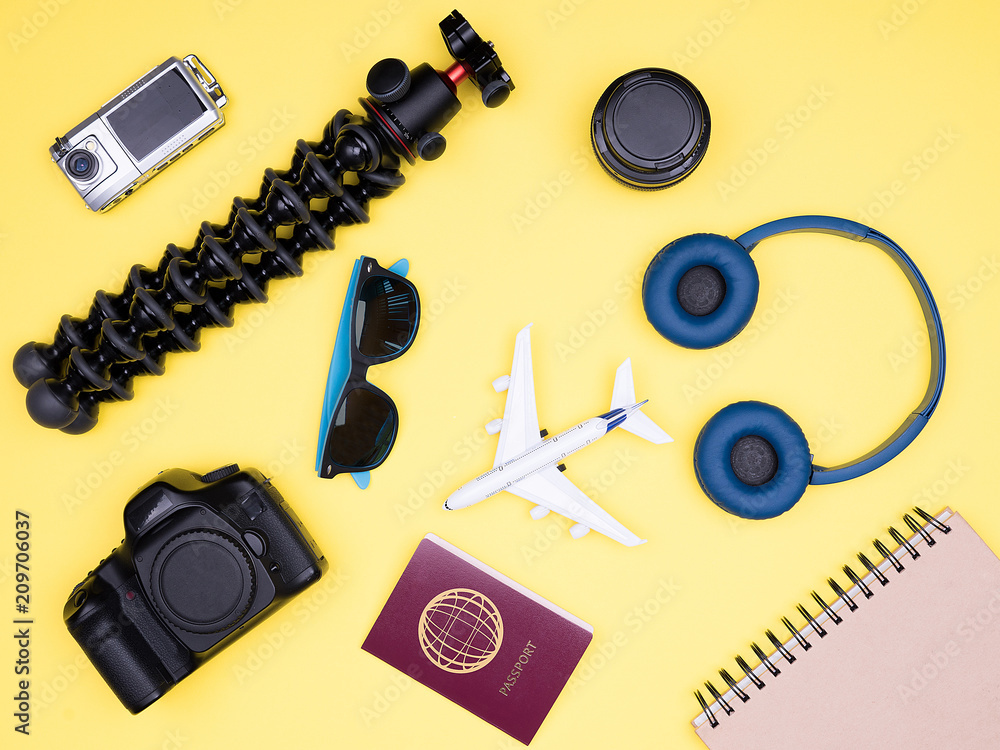 Travel accessories of a hipster photographer on yellow background Travel accessories of a hipster photographer on yellow background