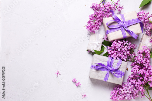 Wrapped  gift boxes with presents  and lilac flowers