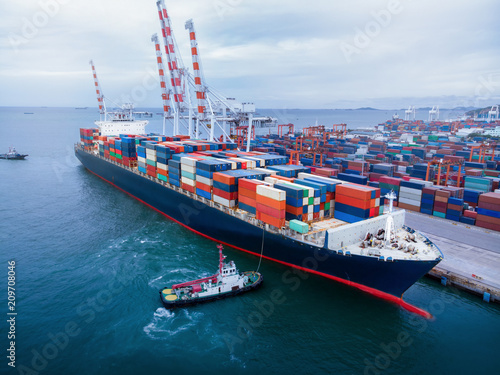 Cargo container ship in the cargo international yard port carrying full load ready to export .