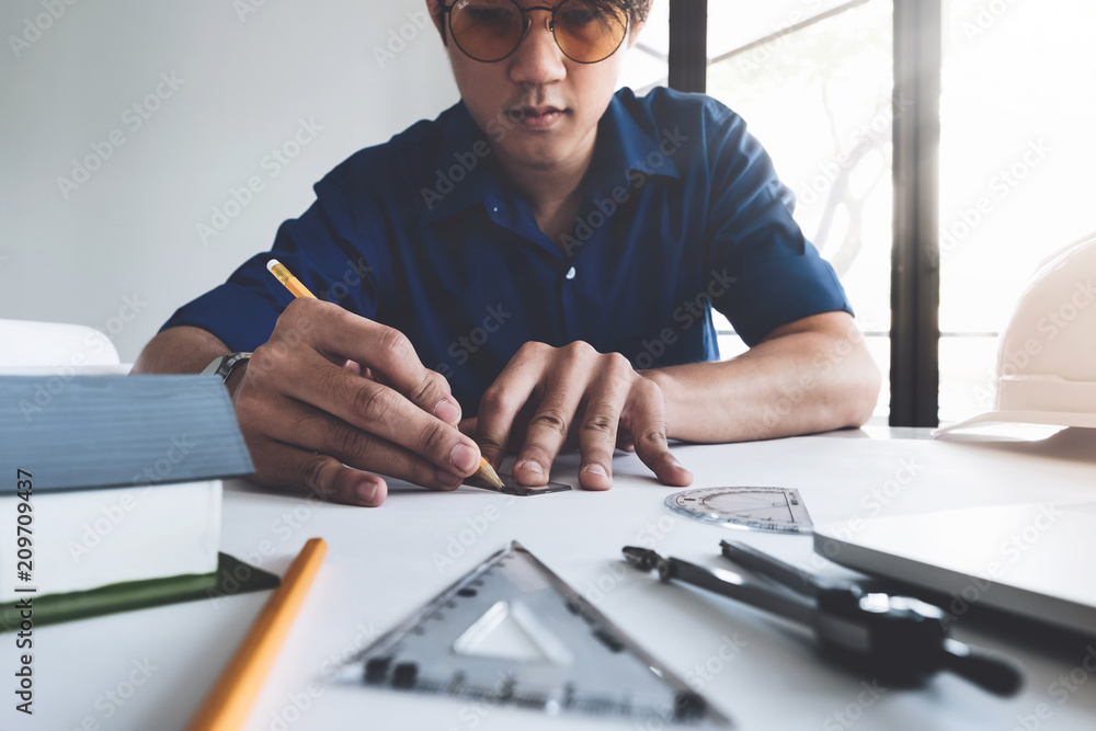 Image of engineer drawing a blue print design building or house, An