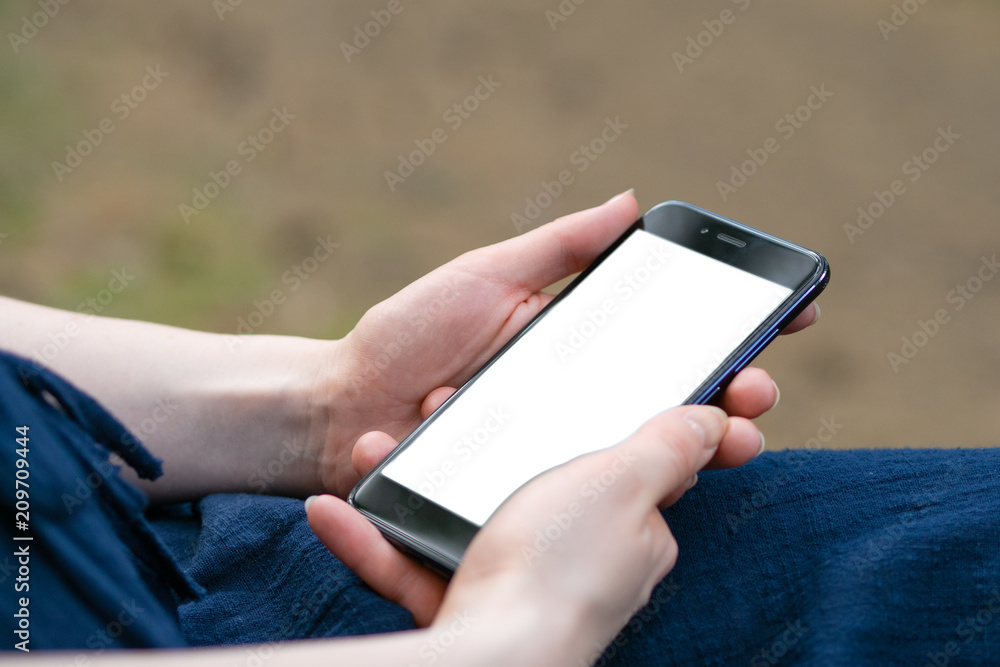 Close up hand hold using smart phone on outdoor park street background