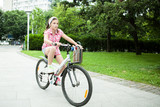 Girl riding her bicycle in the park  enjoying the moment 