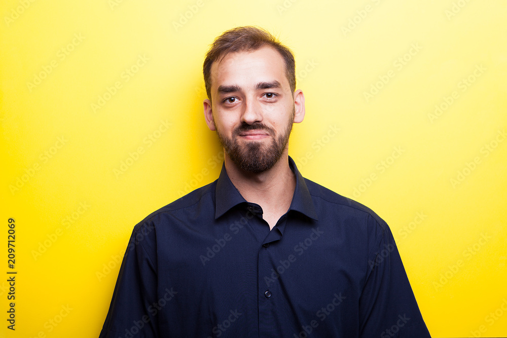Happy joyful man smiling on yellow background in studio photo
Happy joyful man smiling on yellow background in studio photo