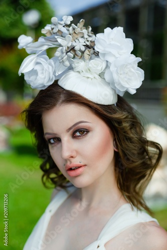 portrait of young sensual woman posing in elegant headwear