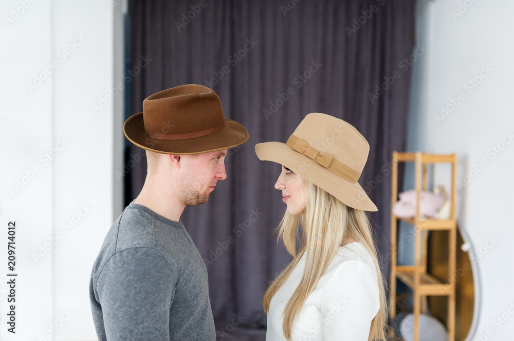 Loving couple in hats face profile, male female couple. Looking at each other