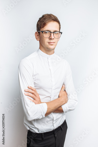 Portrait of young attractive guy in glasses, in white shirt, isolated on white background, for advertising, text insertion photo