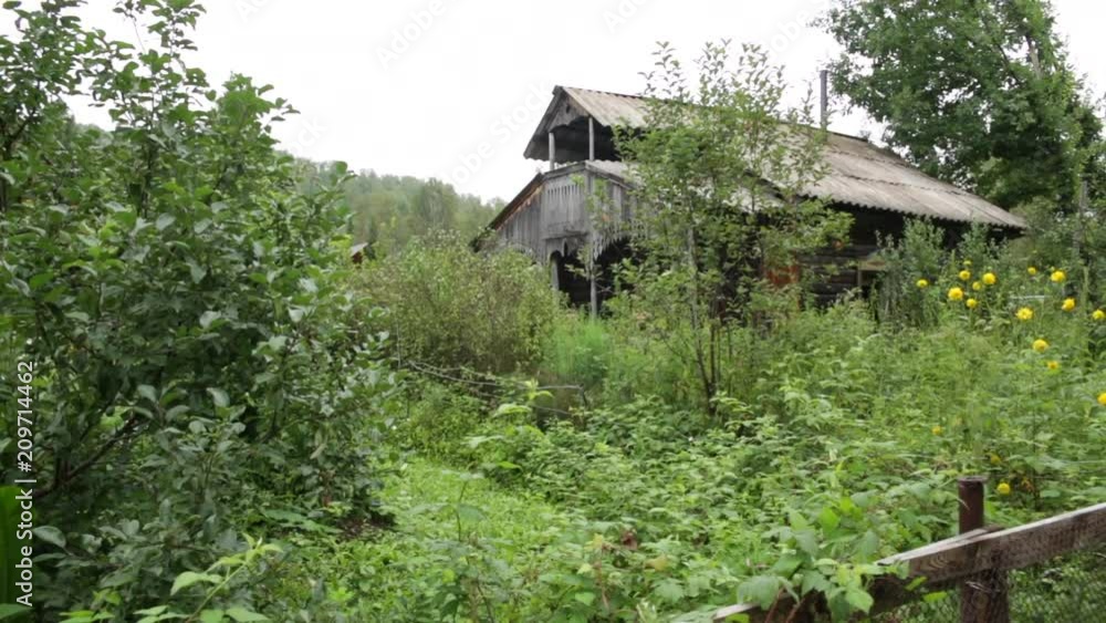 Derelict Typical Traditional Russian village house in Russia - pan Derelict Typical Traditional Russian village house in Russia - pan